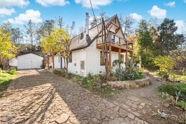 view of home's exterior with a shed