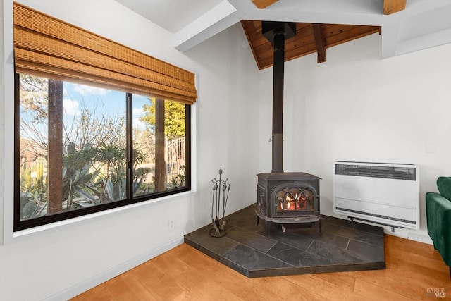 interior details featuring heating unit, hardwood / wood-style floors, and a wood stove