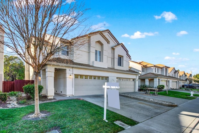 view of front of property with a residential view, stucco siding, driveway, a garage, and fence