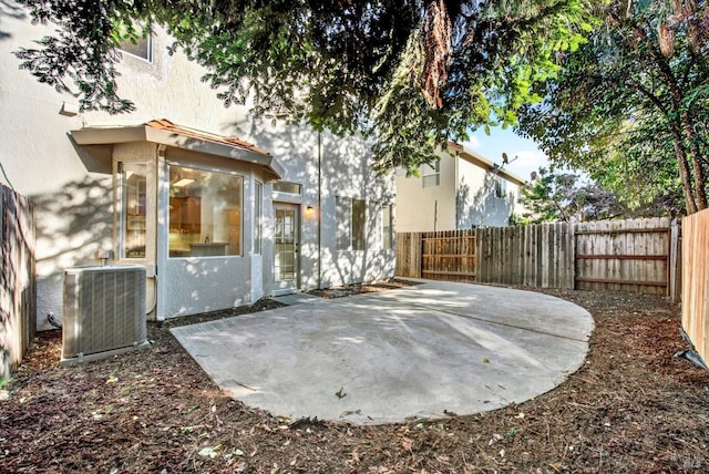 view of patio / terrace with a fenced backyard and central air condition unit