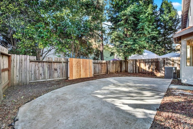 view of yard with cooling unit, a patio area, and a fenced backyard