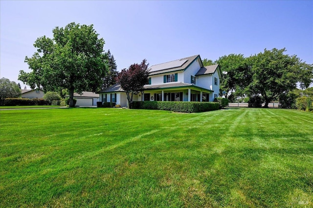 view of front of house with a front lawn and solar panels