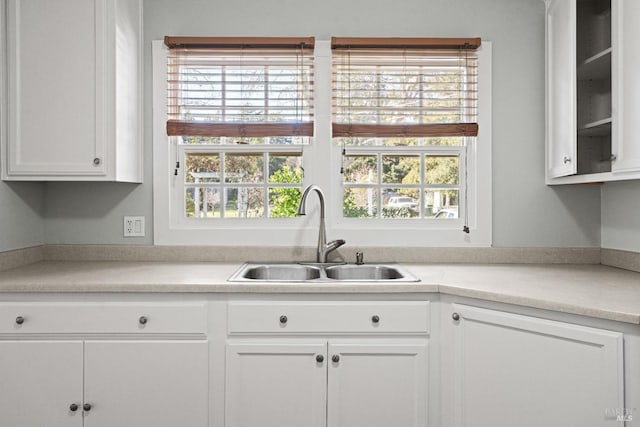 kitchen featuring plenty of natural light, sink, and white cabinets