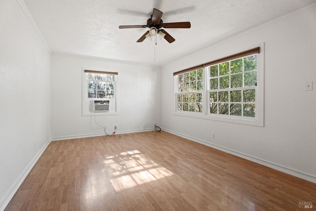 empty room featuring crown molding, ceiling fan, a textured ceiling, and light wood-type flooring