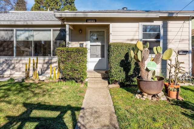 doorway to property featuring a yard