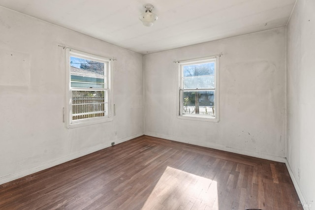 unfurnished room with wood-type flooring