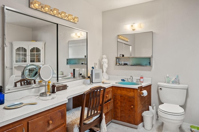 bathroom with toilet and vanity