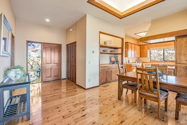 dining room with baseboards and light wood-style floors