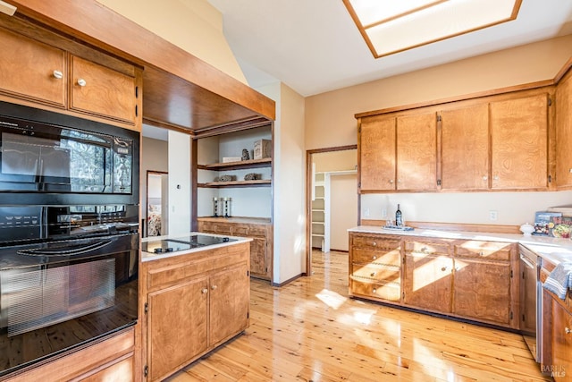 kitchen featuring brown cabinets, light wood finished floors, open shelves, light countertops, and black appliances