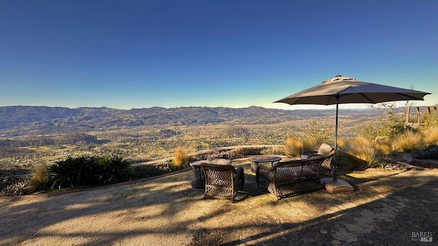 view of yard with an outdoor fire pit and a mountain view