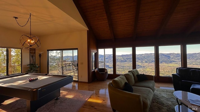 rec room with vaulted ceiling with beams, a mountain view, a notable chandelier, pool table, and wood finished floors