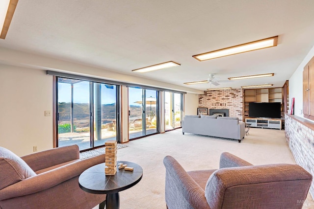 living area with light carpet, a brick fireplace, and ceiling fan