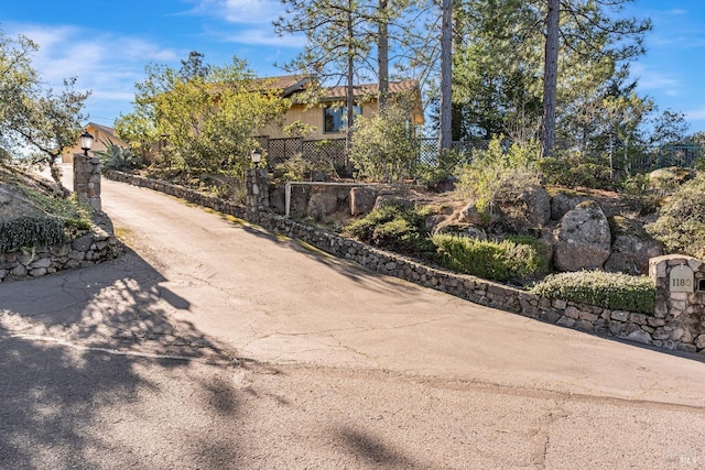 exterior space featuring driveway and street lights