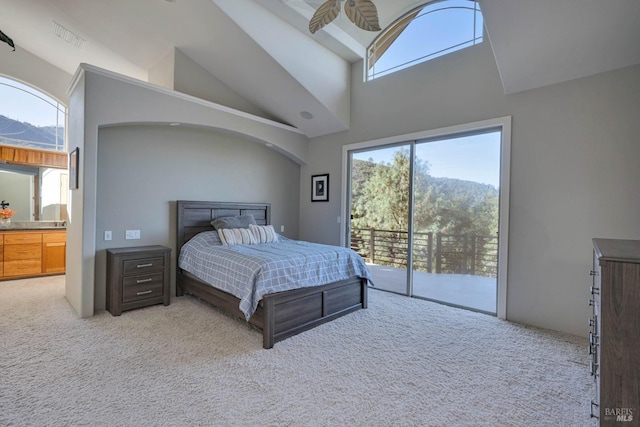 carpeted bedroom with high vaulted ceiling, connected bathroom, access to outside, and ceiling fan