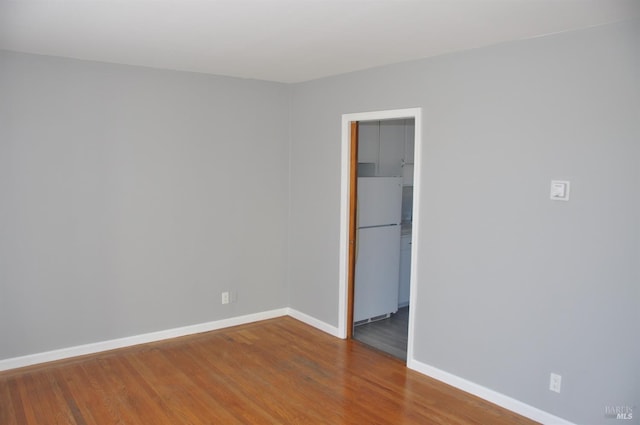 spare room featuring wood-type flooring