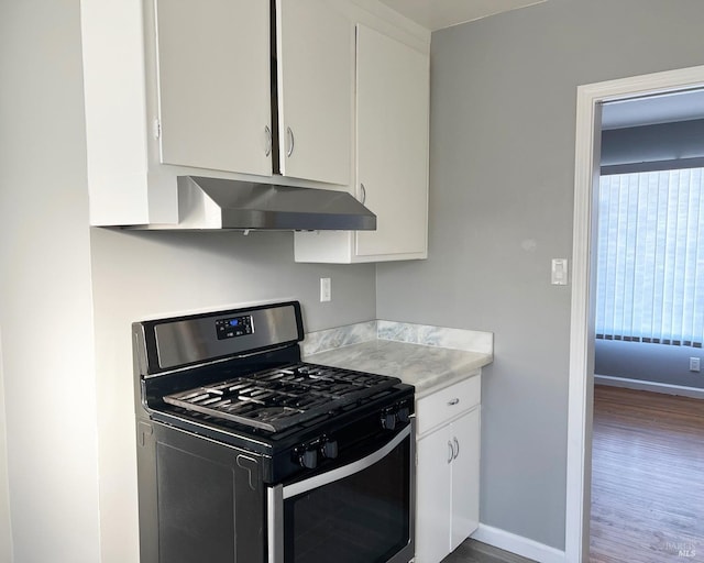 kitchen featuring white cabinetry, dark hardwood / wood-style floors, and gas range