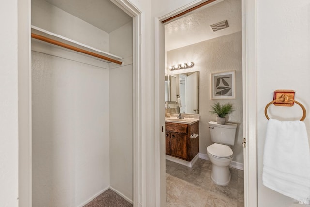 bathroom featuring toilet and vanity