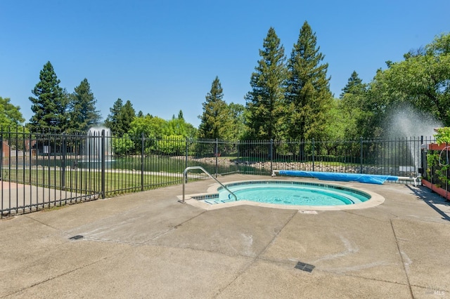 view of swimming pool featuring a patio area and a hot tub