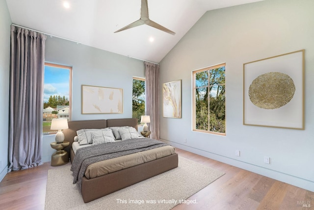 bedroom with ceiling fan, wood-type flooring, and vaulted ceiling