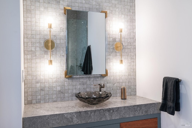 bathroom featuring tasteful backsplash and vanity