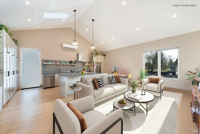 living room featuring a skylight, sink, high vaulted ceiling, light hardwood / wood-style flooring, and a wall mounted AC