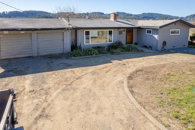 single story home featuring a mountain view and a garage