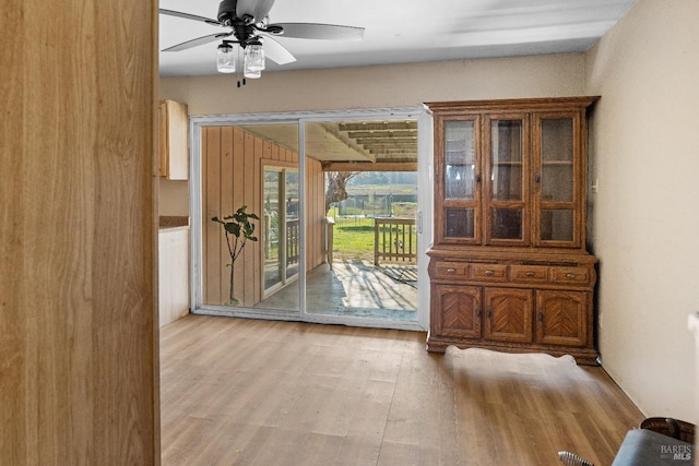 doorway to outside with ceiling fan and light hardwood / wood-style flooring