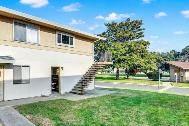 view of property exterior with a yard