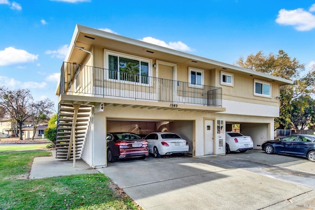 view of property featuring a balcony and a garage