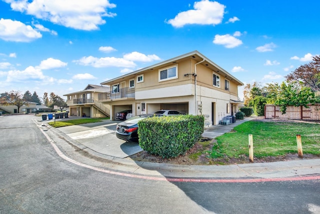 view of front of property featuring a garage and a front lawn