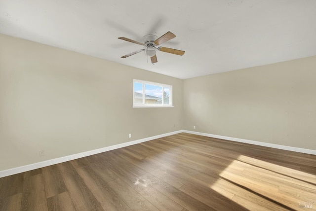 spare room with wood-type flooring and ceiling fan