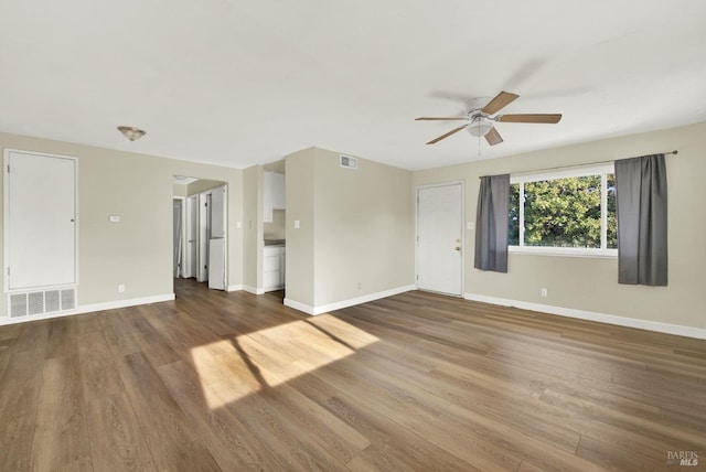 empty room with wood-type flooring and ceiling fan