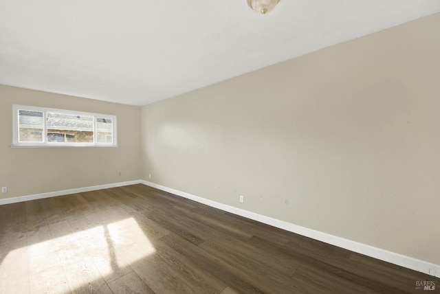 spare room featuring dark hardwood / wood-style floors