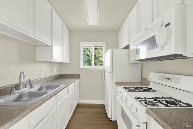 kitchen with white cabinetry, sink, white appliances, and dark wood-type flooring