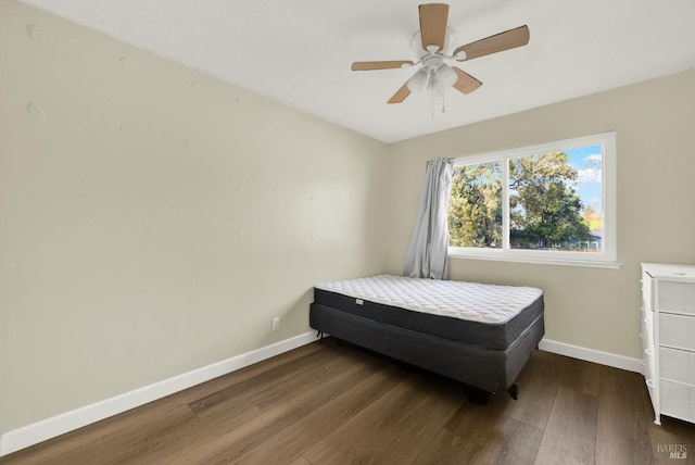 bedroom featuring dark hardwood / wood-style flooring and ceiling fan