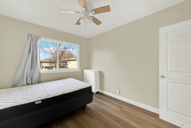 bedroom with hardwood / wood-style floors and ceiling fan