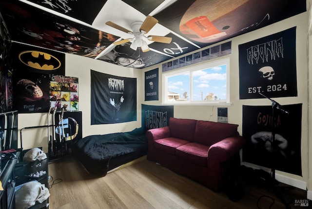 interior space with wood-type flooring and ceiling fan