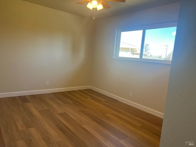 empty room with hardwood / wood-style flooring and ceiling fan