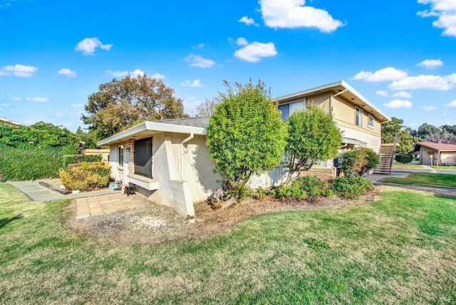 view of property exterior with a yard