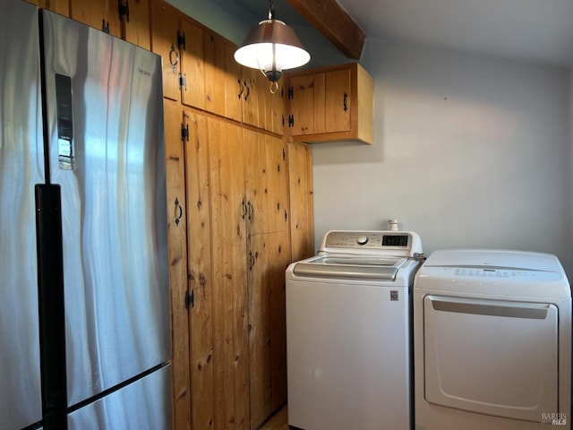 laundry room with cabinets and washing machine and dryer