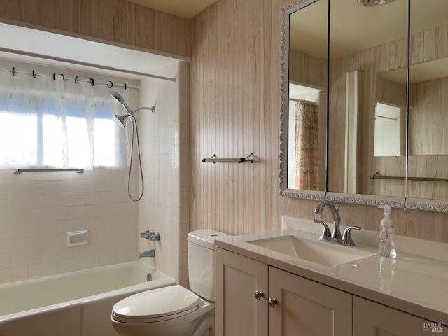 full bathroom with tiled shower / bath combo, vanity, and toilet