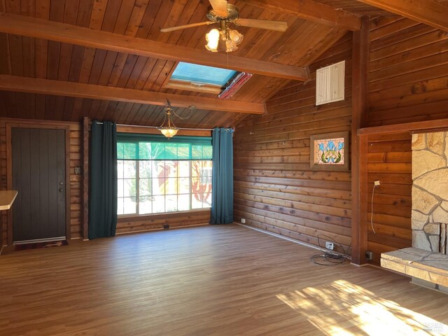 interior space with hardwood / wood-style flooring, rustic walls, lofted ceiling with skylight, and wood ceiling