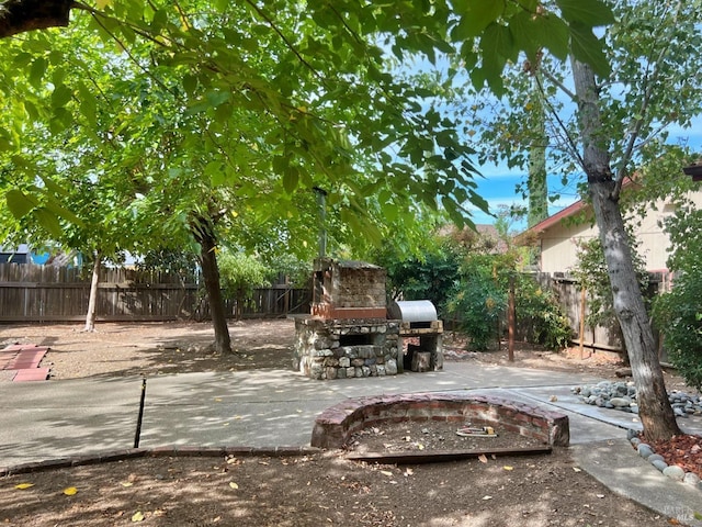 view of patio with an outdoor stone fireplace