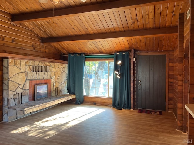 unfurnished living room featuring wood-type flooring, wooden ceiling, lofted ceiling with beams, and a fireplace