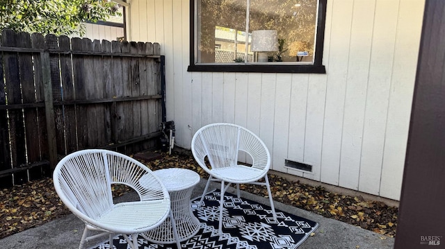 view of patio featuring visible vents and fence