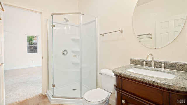 full bath with vanity, a shower stall, and toilet