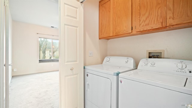 laundry area with light colored carpet, cabinet space, visible vents, separate washer and dryer, and baseboards