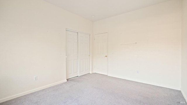 unfurnished room featuring baseboards and carpet flooring