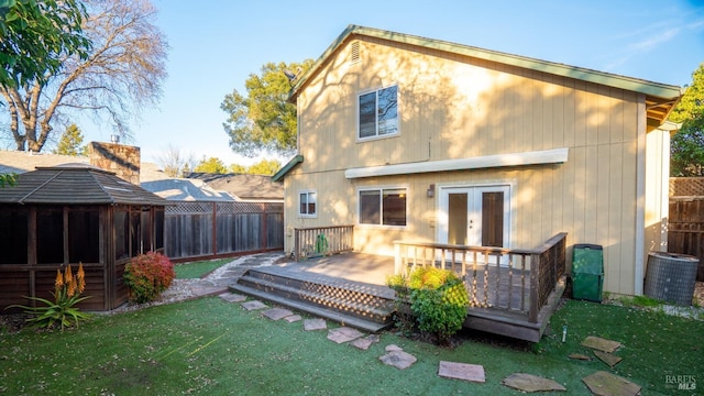 back of house with a yard, french doors, fence, and a wooden deck