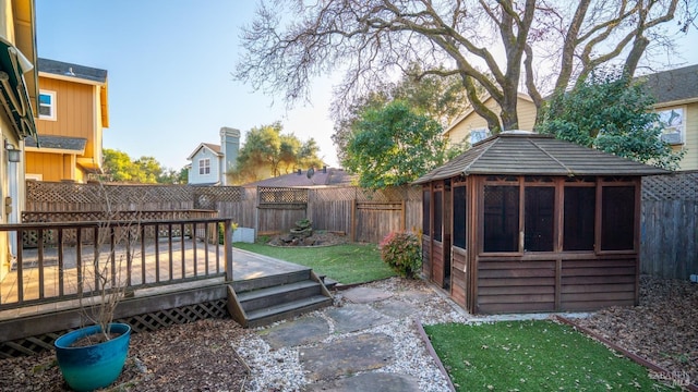 view of yard with a fenced backyard and a deck